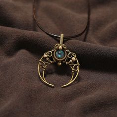 "Step into a world of celestial charm with our exquisitely crafted \"Celestial Serenity\" Copper Wire Wrapped Crescent Moon Pendant, adorned with a captivating Labradorite gemstone. A masterpiece of artistry and elegance, this pendant showcases the mesmerizing dance of colors within the Labradorite, creating an otherworldly allure. Unveiling the Beauty: Indulge in the ageless allure of copper as the skilled hands of our artisans meticulously shape the metal into a gracefully curved crescent moon. The delicate wirework embraces the ethereal Labradorite gemstone, enhancing its natural beauty and radiance. A Captivating Gemstone: The heart of this pendant beats with the enchanting Labradorite, renowned for its celestial play of colors that seems to whisper secrets of distant galaxies. Each an Moon Phase Spiritual Jewelry, Celestial Round Collectible Necklaces, Moon-shaped Brass Necklace For Gift, Moon Shaped Brass Necklace For Gift, Handmade Moon Shaped Necklace, Unique Handmade Moon Shaped Necklace, Handmade Unique Moon Necklace, Celestial Gemstone Jewelry Collectible, Celestial Gemstone Brass Jewelry