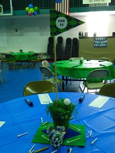 a blue table with green cloth on it and some white balls in the center surrounded by other tables