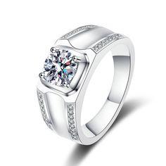 a white gold ring with diamonds on the sides and a center stone in the middle