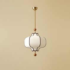 a light fixture hanging from the ceiling with a white and brown glass shade on it