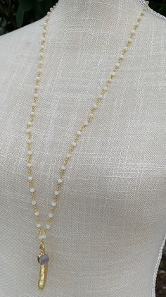 "Pretty white crystal beaded rosary necklace with a gold filled leaf charm and gray druzy charm. Approximately 31\" long. Beautiful along or layered with other necklaces." White Lariat Necklace With Beaded Chain, White Beaded Chain Lariat Necklace, White Lariat Necklace With Gemstone Beads, White Gemstone Beads Lariat Necklace, White Beaded Dainty Crystal Necklace, White Spiritual Necklace With Adjustable Chain, Dainty White Crystal Necklaces, Dainty White Beaded Crystal Necklace, White Spiritual Necklaces For Everyday Wear