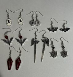 These variations of Halloween/gothic style earrings are to dieee for. They're so cute and perfect for the upcoming soooky season or to just wear all year round!! :) Each one is unique in its own and can be customized to your liking!! READ BELOW  for customization; when choosing a beading type for reference see mismatched bat earrings or the spiderweb earrings, the bead above them is what you would be choosing! if not applicable to your taste, then no worries! <3 Emo Metal Earrings For Halloween, Edgy Handmade Halloween Earrings, Edgy Pierced Halloween Earrings, Edgy Halloween Pierced Earrings, Edgy Handmade Earrings For Halloween, Edgy Pierced Earrings For Halloween, Black Emo Earrings For Gift, Halloween Vampire Metal Earrings, Vampire Style Metal Earrings For Halloween