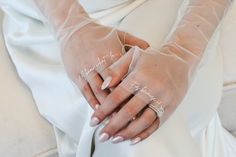 a woman wearing white gloves with writing on her fingers and hand in the middle of her arm