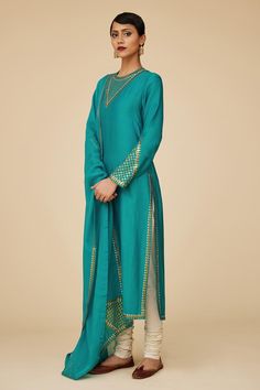 Teal blue full sleeves straight kurta in chanderi base with sequin tikki jaal embroidery on the neckline, sleeves hem and borders. Paired with ivory cotton churidar and embroidered viscose organza dupatta.
Components: 3
Pattern: Embroidery
Type Of Work: Sequin Tikki Jaal
Neckline: Round
Sleeve Type: Full
Fabric: Kurta: Chanderi, Dupatta: Viscose Organza, Churidar: Cotton
Color: Blue
Other Details: 
Length:
Kurta: 46inches
Churidar: 58inches
Dupatta: 2.5metres
Occasion: Puja - Aza Fashions Jaal Embroidery, Cotton Churidar, Chanderi Dupatta, Blue Kurta, Straight Kurta, Pattern Embroidery, Organza Dupatta, Churidar, Full Sleeves