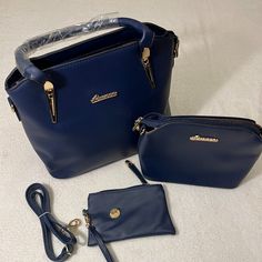 Ainuoer Navy Blue Purse With Gold Accents. Zipper Closure And Pockets Inside. Removeable Shoulder Straps, Comes With A Smaller Purse And Pouch. Measurement: 13"Lx10"Hx5"W. New Blue Bags With Large Capacity And Double Handle, Large Capacity Blue Bags With Double Handle, Blue Large Capacity Satchel Bag, Blue Handheld Shoulder Bag For Daily Use, Blue Satchel Shoulder Bag With Large Capacity, Blue Shopping Bag With Detachable Handle, Blue Satchel With Large Capacity As Shoulder Bag, Blue Shoulder Satchel With Large Capacity, Blue Large Capacity Top Handle Satchel