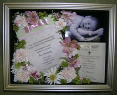 a frame with flowers and a baby's photo