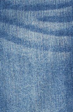 the back side of a pair of jeans with blue denim fabric and white stitching