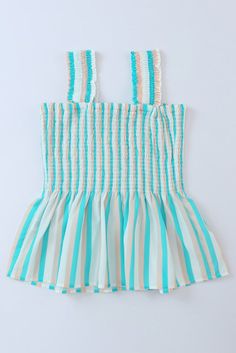 This Aqua Tan Striped Smocked Peplum Tank Top is a summertime staple that's sure to make a splash. Featuring a stylish ruffle strap and smocked bodice, this top will keep you looking stylish and feeling cool all season long. Who said stripes have to be boring. #stripeslikethese Peplum smocked wide strap tank top in aqua, tan and white colors. Fun top for summer with its beach colors and comfy smocked top, has wider straps so it can be worn with a bra without it showing. Roomy fit in waist and sm Summer Cotton Smocked Top With Smocked Back, Cotton Smocked Top With Smocked Back For Summer, Cotton Smocked Dress With Ruffled Straps, Summer Tops With Ruffle Hem And Ruffled Straps, Cotton Tops With Smocked Bodice For Beach, Green Ruffle Hem Tops For Summer, Striped Ruffle Tops For Beach, Cotton Top With Smocked Bodice For Beach, Cotton Smocked Top With Ruffled Straps