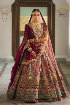 a woman in a red and gold bridal gown