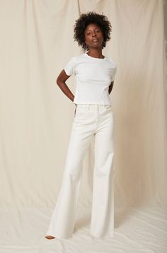 Make a statement in our best-selling high-rise, wide leg silhouette. With an easy fit though the hip and thigh, full inseam, slight distressing at the pockets and a raw frayed hem, they're your new everyday denim. Zip fly. WASH: WHITE OAK FIT & MEASUREMENTS: Inseam = 33" Front Rise = 13" Back Rise = 16" Leg Opening = 23" Measurements taken from size 27 Taliha is wearing a size 24 and is 5'10" Sydney is wearing size 25 and is 5'8" Miracle is wearing size 26 and is 5'10" Take your normal size for Elevated Casual Pants With Five Pockets, High Rise Cotton Wide Leg Pants With Frayed Hem, Chic Mid-rise Flare Jeans For Everyday, Chic Rigid Denim Pants, Fitted Wide Leg Flare Jeans For Everyday, Cotton Mid-rise Flare Jeans For Elevated Casual, Mid-rise Cotton Flare Jeans For Elevated Casual Wear, Chic High Rise Flare Jeans With Five Pockets, Chic Mid-rise Jeans For Elevated Casual Occasions