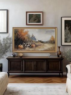 a living room filled with furniture and paintings on the wall