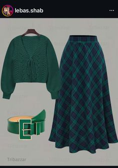 a green sweater and plaid skirt are on display in this screenshoter's image