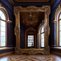 an ornate gold framed mirror in the middle of a room with two large windows and wooden floors