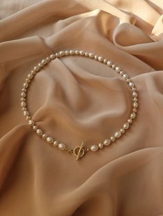 Introducing our dainty pearl necklace - perfect blend of classic elegance with modern touch. This real pearl choker, featuring a gold plated toggle clasp, adorned with moissanite stones,  that add sophistication and charm, making this pearl necklace an ideal for the most important occasions of your life. DETAILS ♦️ Material - 18-karat gold plated premium quality brass ♦️ Real freshwater pearls ♦️ Toggle clasp adorned with dazzling cubic zirconia stones ♦️ Standard size (on the model on the photo Pearl Choker With Pendant, Single Strand Pearl Necklace For Wedding, Elegant Single Strand Necklace For Wedding, Pearl Necklace Clasp, Delicate Round Bead Necklaces For Wedding, Classic Pearl Pendant Necklace For Wedding, Delicate Wedding Necklaces With Round Beads, Gold Single Strand Pearl Necklace For Wedding, Bridal Pearl Jewelry