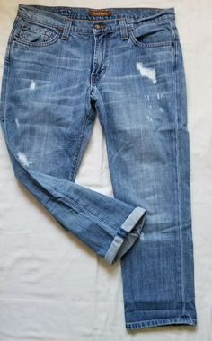 WELCOME TO MY AUCTION!! Up For Bid Women's DAVID KAHN 9.5"Rise Straight Salved 100%Cottton Distressed Fold UP Boyfriend Jeans In Medium Wash Blue! Size 27. Discoloration on back from storage. Smoke and pet free item. Measurements flat on the floor. Waist:                                   34" Rise:                                      9"  Inseam:                                 26" Leg opening:                     7.5" Total length:                     34" David Kahn Jeans, Folded Up, On The Floor, Boyfriend Jeans, On Back, Auction, The 100, Pet, Pants