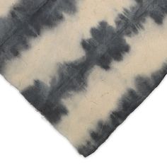 a black and white tie - dyed fabric with small clouds on it's side