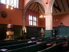 an empty church with pews and stained glass windows