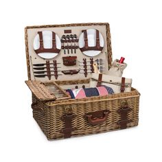 a wicker picnic basket with utensils and other items in it on a white background