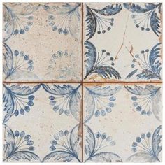 four blue and white tiles with different designs on the sides, all in square shape