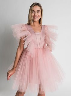 Tulle Dress for Women with Tutu Skirt and Tulle Filling on Shoulders. Perfect choice as a Bridesmaid Dress or in White as Wedding Dress. This Unique dress really puts on a show with tulle filling silhouette. Short Tulle Dress is enough to put anyone in the mood for partying. A.P.Line is more than just a custom-made clothing brand; we are the style experts, the design gurus and the professional seamstresses readily at your service. Express your individuality with a bit of modern luxury that has b Pink Tulle Bridesmaid Evening Dress, Pink Tulle Bridesmaid Dress With Sweetheart Neckline, Pink Princess Tulle Bridesmaid Dress, Pink Princess Bridesmaid Dress In Tulle, Pink Tulle Princess Bridesmaid Dress, Spring Bridesmaid Ball Gown Tutu Dress, Bridesmaid Ball Gown Tutu Dress With Tulle Skirt, Wedding Tulle Tutu Dress Ball Gown, Elegant Bridesmaid Tutu Dress For Prom Season