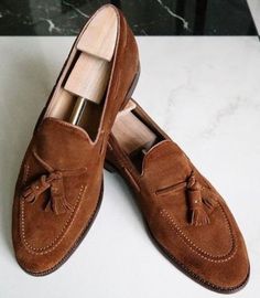 Elevate your footwear game with our handcrafted dark brown tassels loafers, exuding vintage charm and timeless elegance. Made with luxurious brown suede leather, these classic style shoes are meticulously crafted for the modern gentleman who appreciates fine craftsmanship and attention to detail.Whether you're heading to the office or stepping out for a night on the town, these versatile loafers are the perfect choice. Their superior craftsmanship ensures both durability and comfort, making them ideal for long days at the office or special occasions. Pair them with tailored suits for a polished look or dress them down with jeans for a more casual vibe.Invest in quality and style with our handmade tassels loafers, designed to make a statement wherever you go. Add a touch of sophistication t Classic Brown Tassel Loafers For Semi-formal Occasions, Formal Brown Slip-on Tassel Loafers, Brown Slip-on Tassel Loafers, Brown Suede Slip-on Tassel Loafers, Luxury Brown Slip-on Tassel Loafers, Tassel Loafers, Modern Gentleman, Tailored Suits, Brown Suede