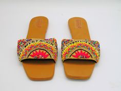 These espadrille like sandals are super cute for the summer, they offer a bright design of floral with leaves to add. These also have a beaded design on some of the flowers and leaves. They are also super comfy with a comfortable sole to walk in all day. These would be cute for a picnic or a photoshoot. Don't miss out on these cute sandals! See our page for more of our collection of shoes we offer. We ship out in a timely matter, wrapped in care for a safe secure trip to your location. Thank you Bohemian Slip-on Sandals For Spring, Spring Beach Espadrille Flats, Beach Sandals With Floral Print And Closed Toe, Spring Beach Sandals With Floral Print, Embellished Summer Beach Sandals, Floral Print Beach Sandals For Spring, Spring Bohemian Flats With Round Toe, Bohemian Spring Flats With Round Toe, Bohemian Round Toe Flats For Spring