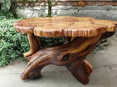 the table is made out of wood and has been carved into a tree trunk with no leaves