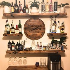 the shelves are full of liquor bottles and glasses on top of each shelf is a bar sign