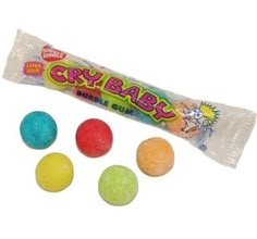 the candy bar is filled with four different colored candies and two gummy balls