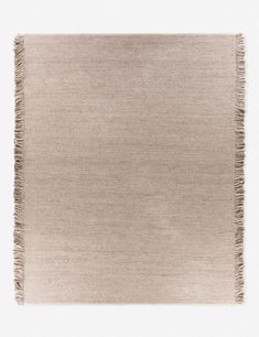 a beige rug with fringes on it