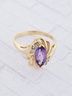 Marquise Diamond Birthstone Ring With Gemstone, Formal Marquise Birthstone Ring, Fine Jewelry Marquise Diamond Ring With Accent Stones, Marquise Diamond Birthstone Ring, Elegant Purple Marquise Cut Amethyst Ring, Elegant Purple Amethyst Ring With Marquise Cut, Purple Marquise Jewelry For Formal Occasions, Purple Marquise Diamond Jewelry, Purple Diamond Marquise Jewelry