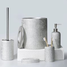 an assortment of bathroom accessories including soap dispenser and toilet brush