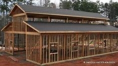 a large wooden building sitting on top of a dirt field