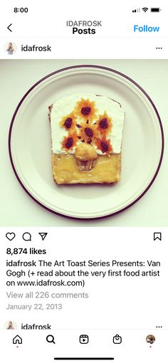 a white plate topped with a piece of cake covered in frosting and sunflowers