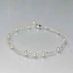 a bracelet with pearls and silver beads