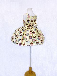 Perfect for photoshoots, pageants, birthdays, or to celebrate any holiday! Knee length dress made out cupcake patterned cotton. Bodice is sleeveless with a zipper on the back. On each side of the waist, there's attached ribbon that can be tied in the back into a bow. Underneath skirt is a layer of lining with crinoline attached to give the bottom shape. The dress is meant to be knee length. *Mannequin has petticoat to show detail. !PETTICOAT NOT INCLUDED! LINK TO PURCHASE PETTICOAT: https://www. Spring Sleeveless Pageant Dress, Sleeveless Spring Pageant Dress, Summer Princess Sleeveless Pageant Dress, Sleeveless Princess Pageant Dress, Princess Sleeveless Pageant Dress, Sleeveless Summer Pageant Dress, Fitted Sleeveless Princess Pageant Dress, Summer Sleeveless Pageant Dress For Party, Sleeveless Summer Pageant Dress For Party