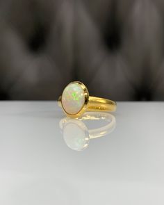 Certificated Natural Opal Dainty Cabachon Ring * 14K Solid Gold & Genuine Opal Stone * Best Gift for her * Handmade Ring ◎ Details ◎ ○ Gemstone Details .Natural OPAL Oval Cut 10.16X8.09 mm approx. 1.53 ct ○ Gold Details 14K Solid Gold Width of Band : 3.00 mm Weight of Ring : approx 4.60 gr Made to Order HANDMADE ITEM ○ Upgrade to Solid 18K Gold, please click the link below: https://www.etsy.com/listing/962826004 ◎ For more CABACHON BEZEL rings : http://etsy.me/37fvI60 All of our jewelleries Luxury Gold Opal Ring With Bezel Setting, Luxury Gold Opal Ring With Cabochon, Classic Opal Moonstone Ring As Gift, Formal Hallmarked Oval Cabochon Opal Ring, Luxury Round Opal Rings, Gold 14k Opal Ring As Gift, 14k Gold Opal Ring For Gift, Luxury Gold Moonstone Ring With Oval Cabochon, Luxury Gold Opal Ring Oval Cabochon