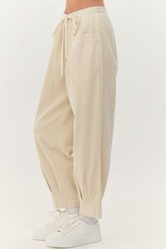 Cream cotton, drawstring pants with an elastic waistband and front pockets, pleat detail at the bottom. Sizes S, M and L Fabric: 100% cotton Relaxed Cotton Pants With Pull-on Style, Relaxed Bottoms With Drawstring For Fall, Relaxed Drawstring Bottoms For Fall, Relaxed Cotton Pants With Side Pockets, Cotton Wide Leg Sweatpants With Pull-on Style, Cotton Sweatpants With Loosely Fitted Hips, Relaxed Cotton Pants With Elastic Waistband, Cotton Pants With Elastic Waistband For Loungewear, Comfortable Cotton Sweatpants For Daywear