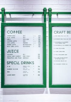 two green menu boards on the side of a white brick wall in front of a sign that says craft beer