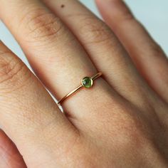 A simple 14k gold-filled or sterling silver band encrusted with your choice of birthstone Peridot gemstone in the center! ∙ Gift Ready in a jewelry box! ∙ Handmade in Vancouver, Canada.  ∙ 100% 14k Gold Fill or Sterling Silver ∙ Rings Sold Individually Please note: All stones due to its nature will vary in colour, flash and hue! --------------------------------- M E A S U R E M E N T :  Width: 1.25mm  Gemstone: 4mm  Size: Optional (US measurement) If your ring size is not specified as an option, Everyday Rings With Gemstone And Recycled Gold, Everyday Gemstone Rings In Recycled Gold, Everyday Gemstone Ring For May Birthstone, Everyday Round Cut Gemstone Birthstone Ring, Minimalist Gold Birthstone Ring With Gemstone, Minimalist May Birthstone Stackable Ring, Minimalist Gold Stackable Rings For May Birthstone, Adjustable Yellow Gold Emerald Birthstone Ring, Adjustable Yellow Gold Emerald Ring With Birthstone