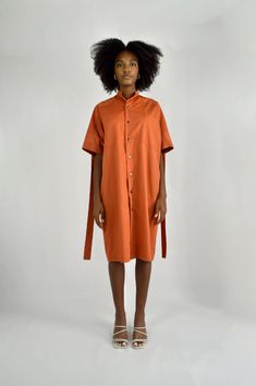 Made in FranceProduct description : - Orange cotton twill midi dress,- Short sleeves,- Mandarin collar,- Pleated in the back,- Tab in the back,- 2 patch pockets on the front,- Buttoned front closure with 8 metal snap buttons.Each piece is made by hand and in small series in our Parisian workshop in the 12th arrondissement, to meet our ecological commitments based on upcycling and slow fashion.Adopt Louise Marcaud's values, showing that today, it is important to consume differently. Wear award-wi Cotton Midi Dress With Button Closure, Cotton Midi Dress With Buttons For Daywear, Cotton Midi Dress With Button Closure For Daywear, Cotton Day Dress With Button Back, Cotton Dresses With Button Closure For Daywear, Cotton Daywear Dress With Button Back, Cotton Short Sleeve Shirt Dress For Fall, Cotton Midi Dress With Buttons For Work, Fall Cotton Shirt Dress With Short Sleeves