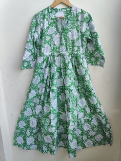 "This dress may look like a simple one but it fits and falls like a dream. Flattering to all body types, it has a shirt collar and box pleats in the skirt area. It has a big flare and the excess frill at the lower part makes it fall so well. Bonus- It comes with two pockets !! PRODUCT DETAILS - Fabric- 100% Cotton - Fir and flare - Pockets on sides - Gentle Hand Wash - Made in India Sizing- Our sizing is in inches. Please refer to the sizing below before placing your order. These are GARMENT MEASUREMENTS. Length of the Dress- 50\" 2XS- BUST- 32″, WAIST- 30″, HIPS- 36″ XS: BUST- 34″, WAIST- 32″, HIPS- 38″ S: BUST- 36″, WAIST- 34″, HIPS- 40″ M: BUST- 38″, WAIST- 36″, HIPS- 42\"\" L: BUST- 40″, WAIST- 38″, HIPS- 44″ XL: BUST- 42″, WAIST- 40″, HIPS- 46″ XXL: BUST- 44″, WAIST- 42″, HIPS- 48″ 3X Printed Long Sleeve Relaxed Fit Dress, Fitted Cotton Maxi Dress With Block Print, Green Maxi Dress Regular Fit, Long Sleeve Relaxed Fit Dress With Floral Print, Fitted Block Print Maxi Dress For Summer, Green Printed Dresses With Relaxed Fit, Knee-length Cotton Dress, Spring Short Sleeve Block Print Dresses, Short Sleeve Cotton Maxi Dress With Print