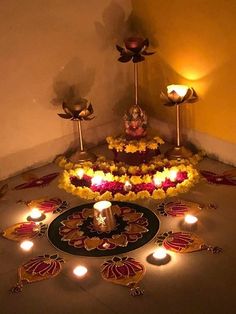 an arrangement of flowers and candles on the floor