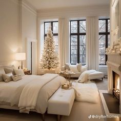 a bedroom decorated for christmas with white furniture and a large tree in the window sill