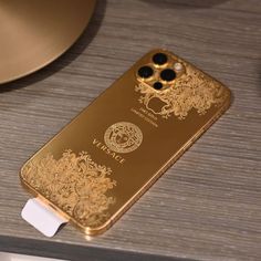 a gold cell phone sitting on top of a table