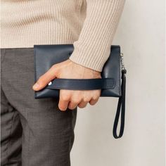 A leather men's clutch is an indispensable item for a modern business man.The accessory is made by hand. Strong genuine leather was used for tailoring.Inside the accessory there are two large compartments and 10 pockets for cards and business cards. There is also a zipper pocket on the front outer wall of the accessory for coins and other small items.The button clutch closes. For convenience, the accessory is equipped with a removable leather loop, which allows you to wear the accessory on the w Men’s Purse, Small Man Bags, Leather Bags For Men, Clutch Bag Pattern, Men Purse, Mens Pouch, Formal Bag, Men Clutch Bag, Interview Outfits