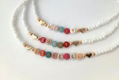 This darling name necklace is so sweet, colorful and surely will make a perfect birthday gift, Christmas gift or and every day favorite accessory  100% made to order and handcrafted with excellence and precision into a beautiful, personalized name necklace that is so special and perfect for gift giving. Arrives in a white gift box with a bow ready for gifting. The colorful beads are carefully chosen to form a random color design for a personalized style. We use strong stretch cord to string the Cute Personalized Multicolor Charm Necklaces, Handmade White Beaded Necklaces For Valentine's Day, Handmade White Beaded Necklace For Valentine's Day, Cute Heart-shaped Beaded Necklace For Gifts, Cute Multicolor Jewelry For Personalized Gifts, Cute Personalized Beaded Jewelry, Cute Beaded Jewelry For Personalized Gift, Cute Personalized Multicolor Jewelry Gift, Valentine's Day Birthday Beaded Jewelry