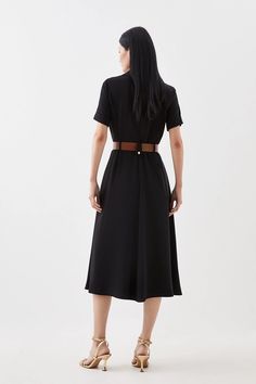 An ode to sophistication and timeless design, soft tailoring immerses this dress with short sleeves, a notched collar and waist belt adding touches of refinement above and a graceful skirt that flows to a midaxi hemline below. Perfect for emanating poise at professional events and special occasions alike.Soft TailoringShort SleevedNotched collar and waist belt Classic Belted Shirt Dress For Semi-formal Occasions, Black Belted Midi Dress For Semi-formal Occasions, Chic Belted Shirt Dress For Evening, Knee-length Belted Shirt Dress For Semi-formal, Classic Tie Waist Shirt Dress For Formal Occasions, Elegant Midi Length Shirt Dress With Belted Cuffs, Fitted Midi Length Dress With Belt, Short Sleeve Belted Evening Dress, Chic Formal Maxi Dress With Belted Cuffs