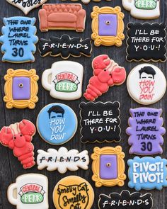 decorated cookies with funny sayings and pictures on them are displayed in front of a wooden table