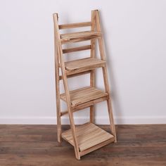 a wooden ladder leaning against a white wall